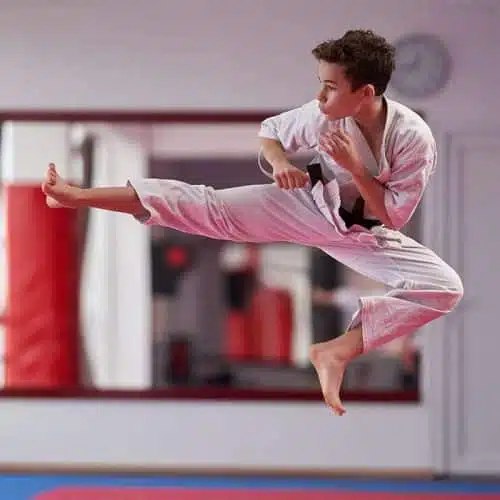 Student practicing techniques in martial arts for teens class.