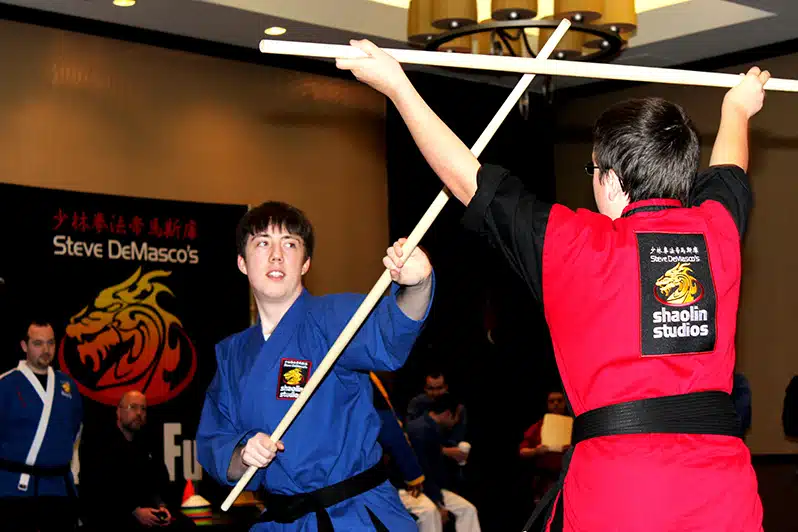 Students practicing a variety of martial arts styles in class.